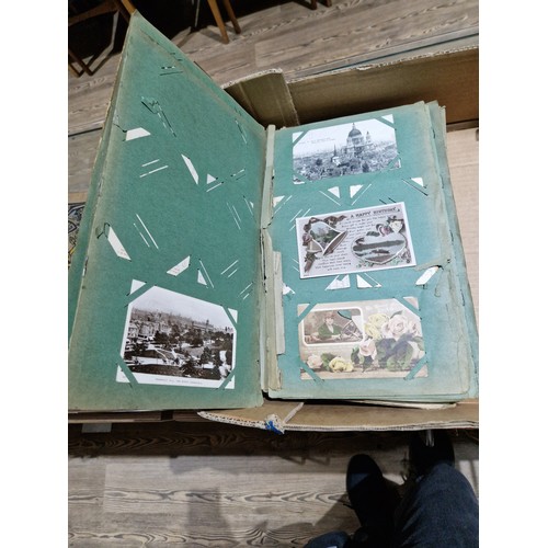 272 - A box of early 20th century postcards albums.