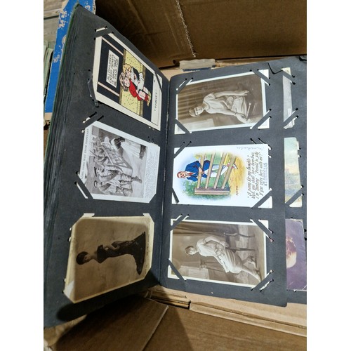 272 - A box of early 20th century postcards albums.