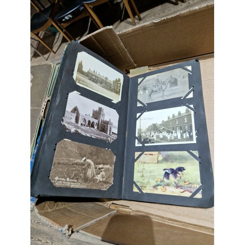 272 - A box of early 20th century postcards albums.