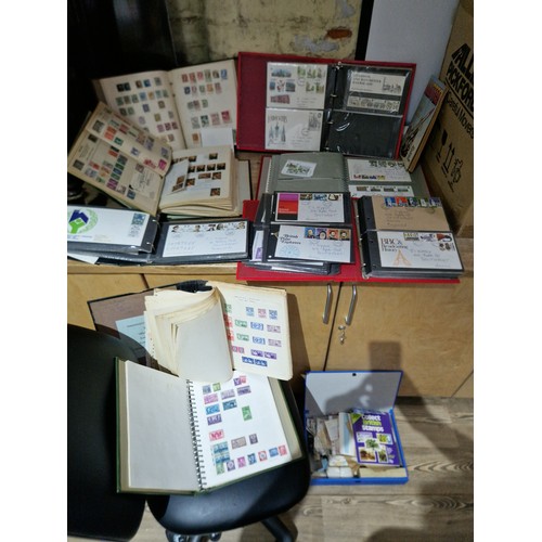 307 - A box of assorted stamp albums, FDCs, loose stamps.