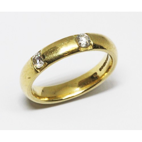 8 - An 18ct gold diamond wedding band, two round brilliant cut stones weighing approx. 0.10cts each, hal... 