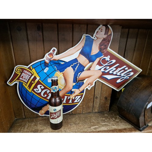 18 - A Schlitz beer metal advertising sign and bottle torch.
