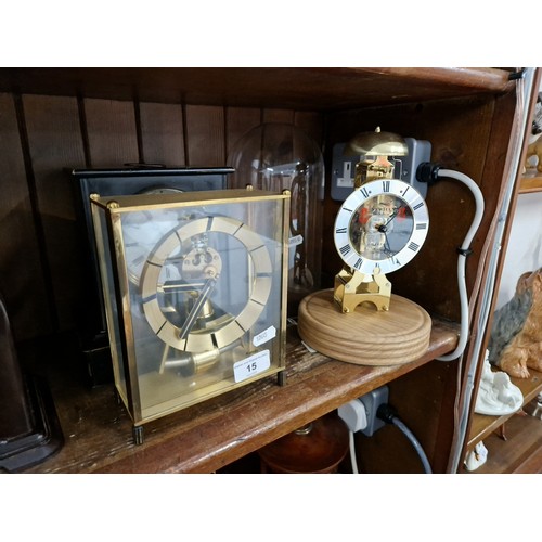 15 - Three clocks, one battery operated, a reproduction Sewills clock under a glass dome and a slate mant... 