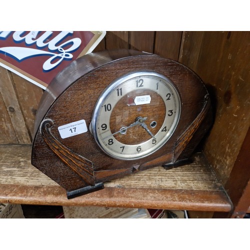17 - An oak cased mantle clock with key and pendulum