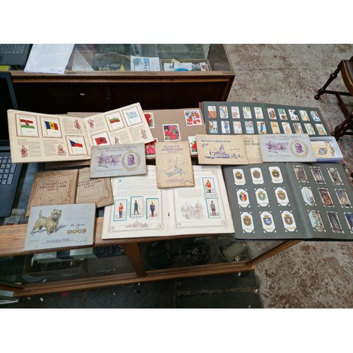 40 - A collection of albums of cigarette cards and a small box of loose Kensitas Silk Flags of the Britis... 