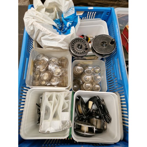 77 - A box of assorted items including three tubs of watch glasses, a tub with fly fishing reels and a mu... 