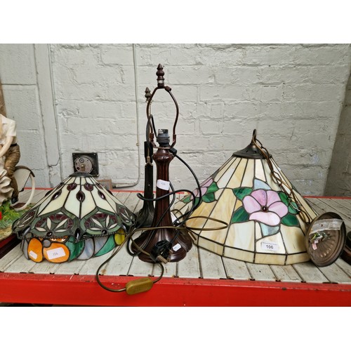 106 - Three Tiffany style lamps with shades and one ceiling light fitting which has some damage to the sha... 