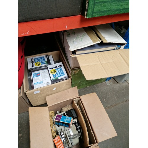 133 - Four boxes of assorted items including books, cine projector and accessories, a box of Sudoko DVD's ... 