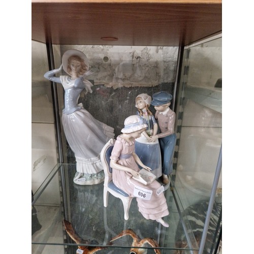 696 - Three Lladro figurines. Girl seated, reading, Dutch boy and girl, and Girl holding hat in breeze