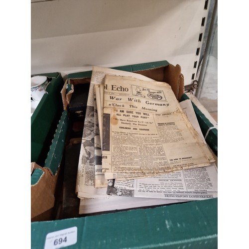 694 - A box of mixed items including boxed cutlery, book, and vintage newspapers