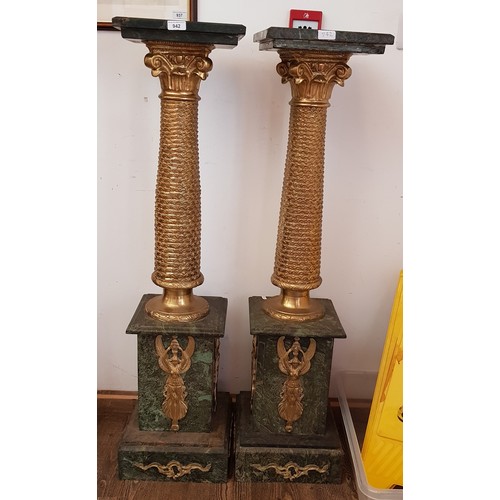 942 - A pair of Egyptian Revival gilt metal and green marble pedestals, height 116.5cm.