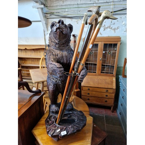 945 - A Black Forest style cast resin stick stand modelled as a bear, height 91cm (approx).