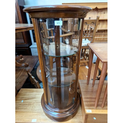 971 - A cylindrical glass display cabinet.