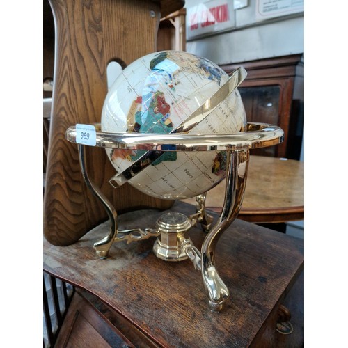 969 - A table top terrestrial globe inlaid with various semi precious stones.