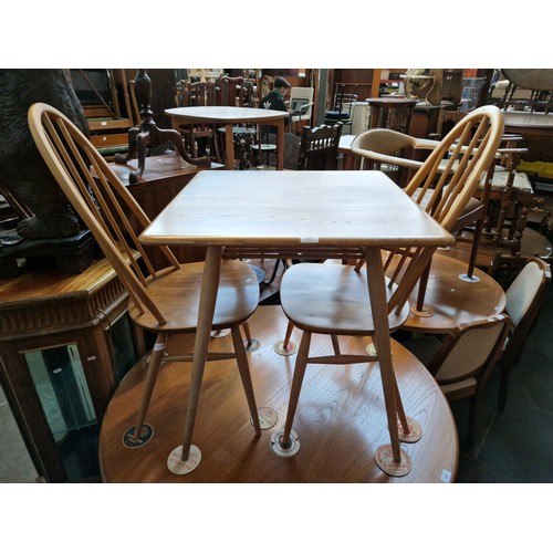 979 - A mid 20th century Ercol light elm breakfast table (model 395) together with two Ercol 'Quaker' chai... 