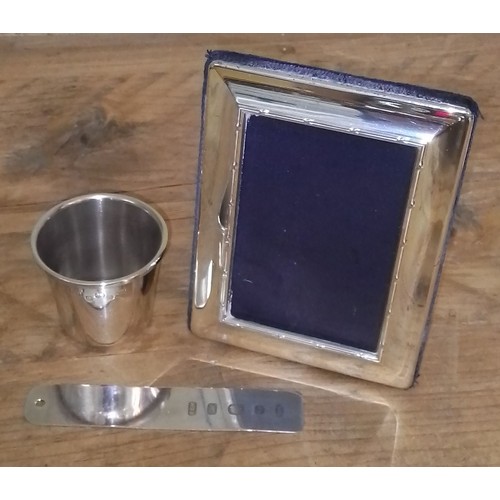 85 - Hallmarked silver comprising a shot measure, a bookmark and a photograph frame.