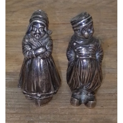 95 - A pair of Dutch imported silver salt and pepper pots modelled as a man a woman, height 7cm, weighted... 