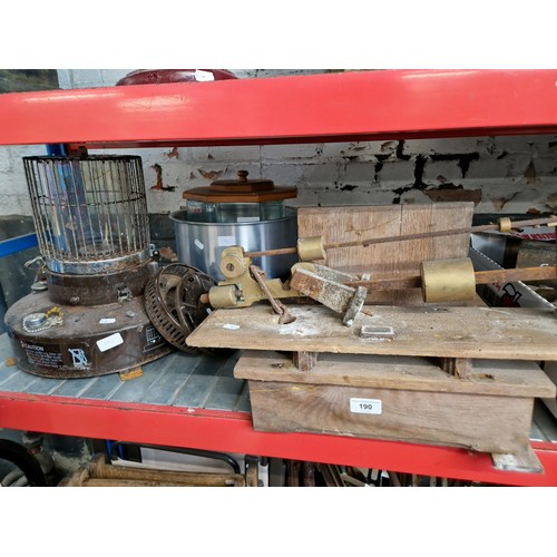 190 - A paraffin heater, a vintage balance scale, a glass display case and a metal bowl