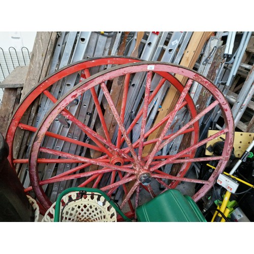 242 - A pair of metal cart wheels with metal rims, diameter 60 inches