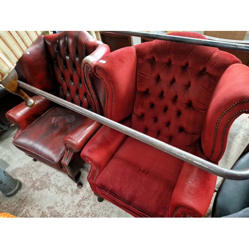 1094 - A wingback armchair, stool, and an oxblood red leather wingback armchair.