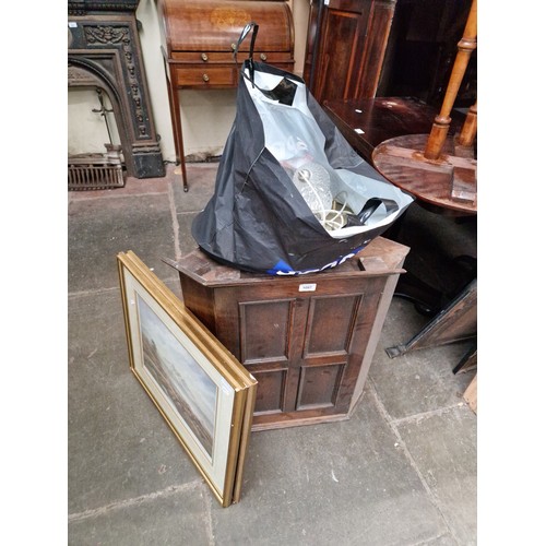 1097 - An oak corner cabinet, two signed prints and a drop light fitting.