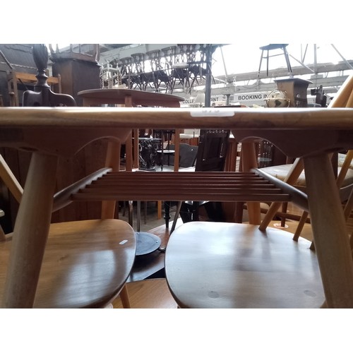 979 - A mid 20th century Ercol light elm breakfast table (model 395) together with two Ercol 'Quaker' chai... 