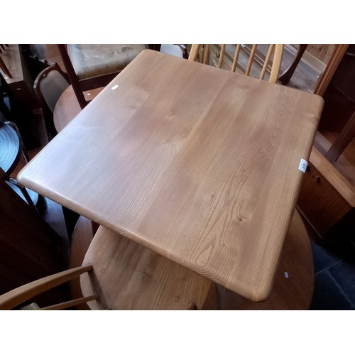 979 - A mid 20th century Ercol light elm breakfast table (model 395) together with two Ercol 'Quaker' chai... 