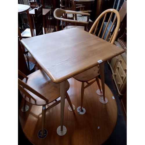 979 - A mid 20th century Ercol light elm breakfast table (model 395) together with two Ercol 'Quaker' chai... 