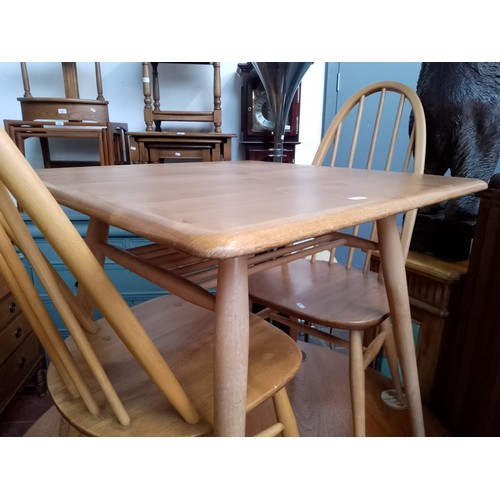 979 - A mid 20th century Ercol light elm breakfast table (model 395) together with two Ercol 'Quaker' chai... 