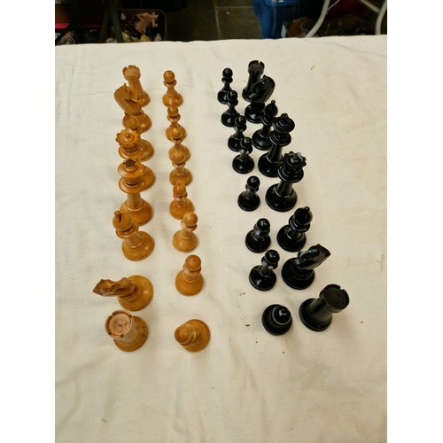 46 - Two chess sets, one soapstone and one wooden, together with another set of pieces.