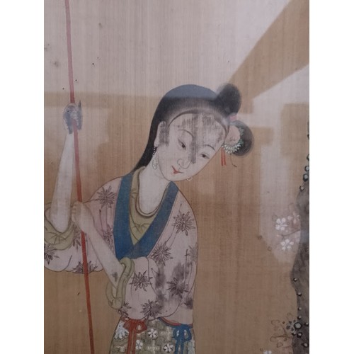 923 - A framed Japanese painting on silk depicting a woman on a boat.