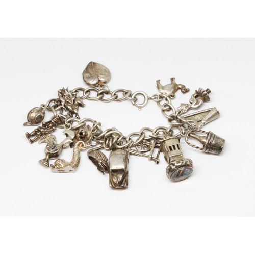 184 - A charm bracelet marked 'Sterling', length 18cm, wt. 46.5g.