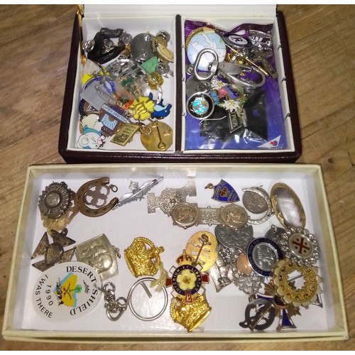 213 - Two boxes of military and other badges and brooches etc.