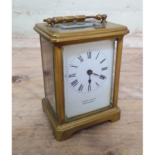 271 - A gilt brass carriage clock, white enamel dial signed Henry Wells, Shrewsbury.