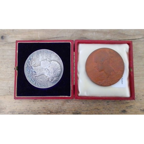 281 - Queen Victoria 1897 silver medallion and a bronze similar.