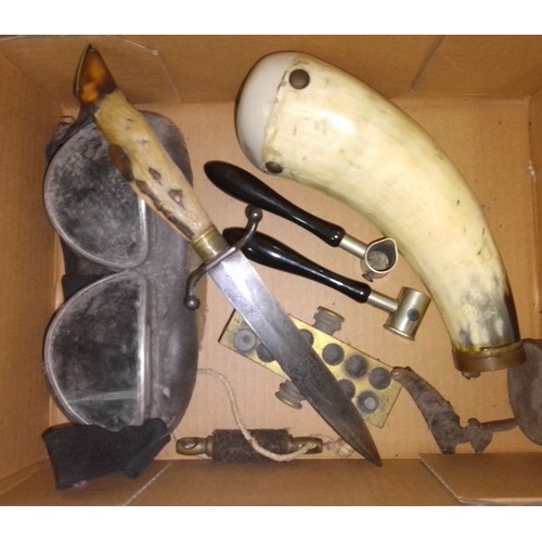 183 - A mixed lot including a hoof handled hunting knife, a pair of goggles, a cow horn shot powder flask ... 