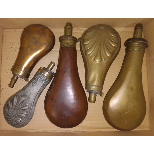 181 - A group of five shot powder flasks.
