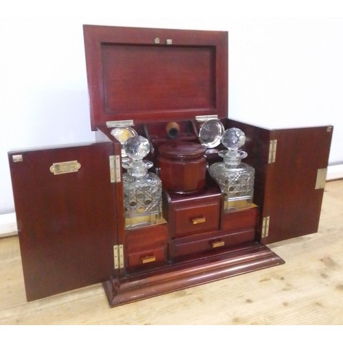 439 - An early 20th century mahogany smoker's cabinet/decanter box, labelled Waring & Gillow, assorted con... 