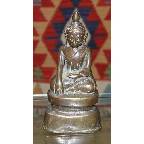 491 - An eastern bronze seated buddha, height 23cm.