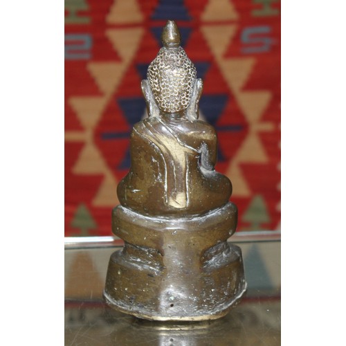 491 - An eastern bronze seated buddha, height 23cm.