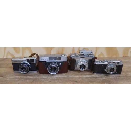 472 - Four assorted cameras comprising a Russian rangefinder type camera, an Olympus Trip 35, a Mamiya and... 