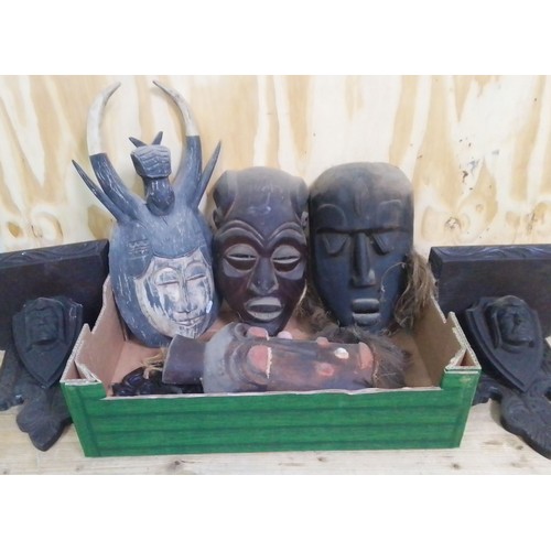 458 - A box of assorted wooden masks and a pair of brackets.