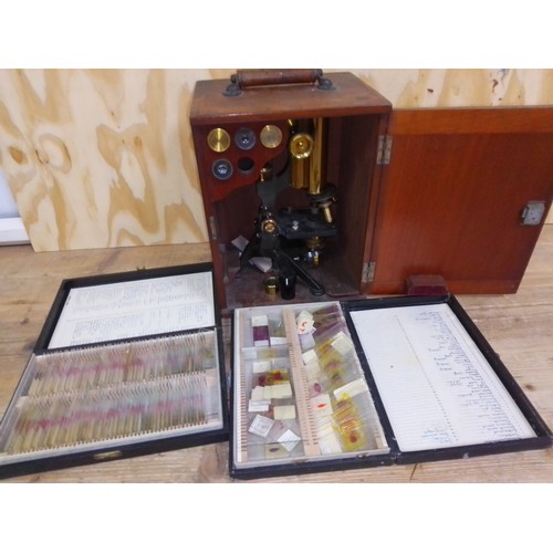 464 - A W Watson & Sons microscope with mahogany case, lenses, and two cases of slides.