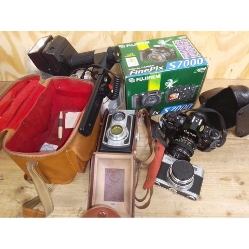 478 - A box of cameras and accessories including a Weltaflex medium format camera, a CanonA-1 etc.