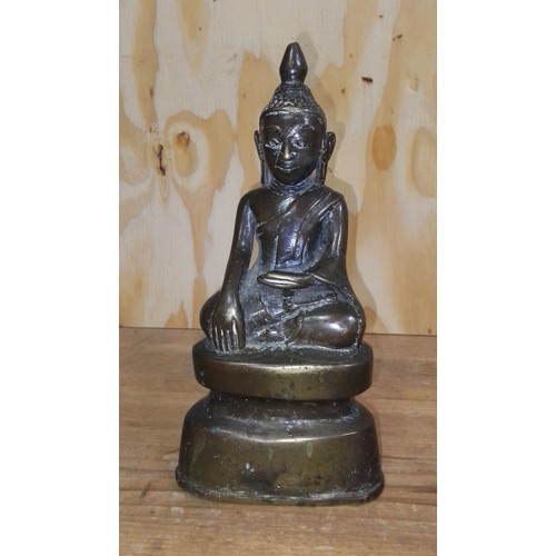 491 - An eastern bronze seated buddha, height 23cm.
