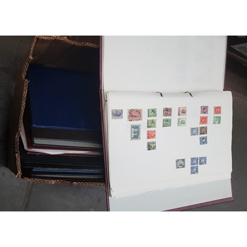 69 - A box of assorted stamp albums to include mint stamps.