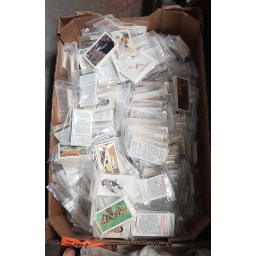 84 - A box of assorted cigarette cards.