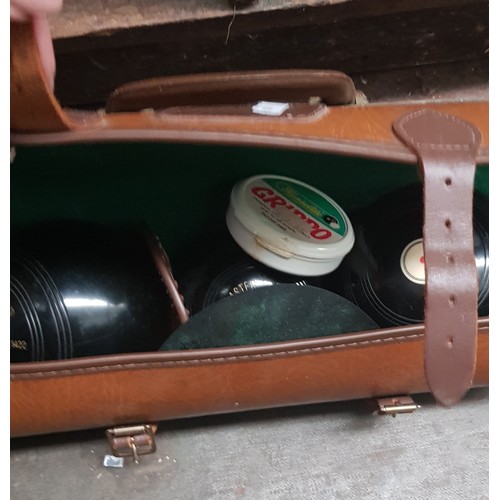 91 - A set of crown green bowls with jack, in leather case