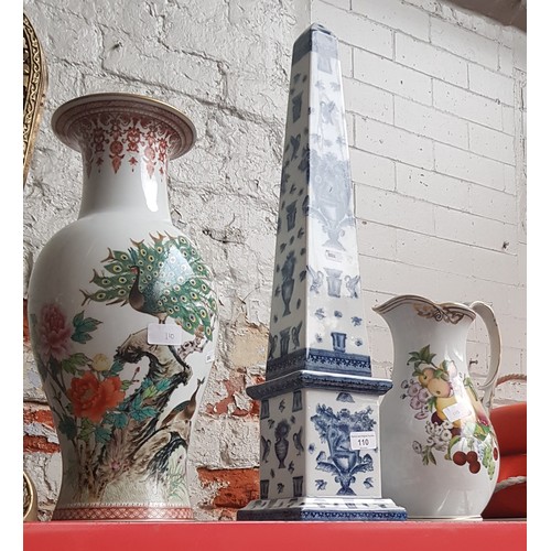 110 - A large jug with fruit pattern, a large blue and white obelisk, and a large oriental vase