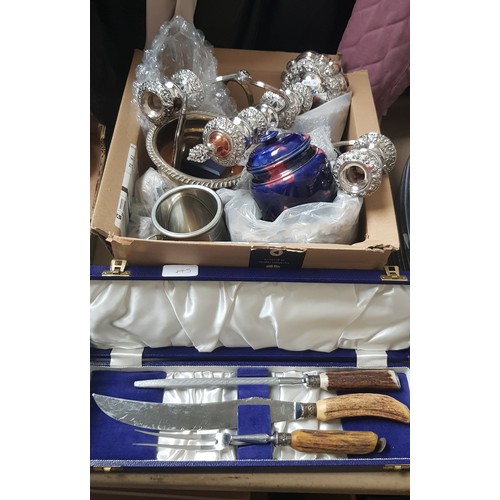 145 - A box of assorted metal ware including a candelabra, silver plated ware, horn handled carving set et... 